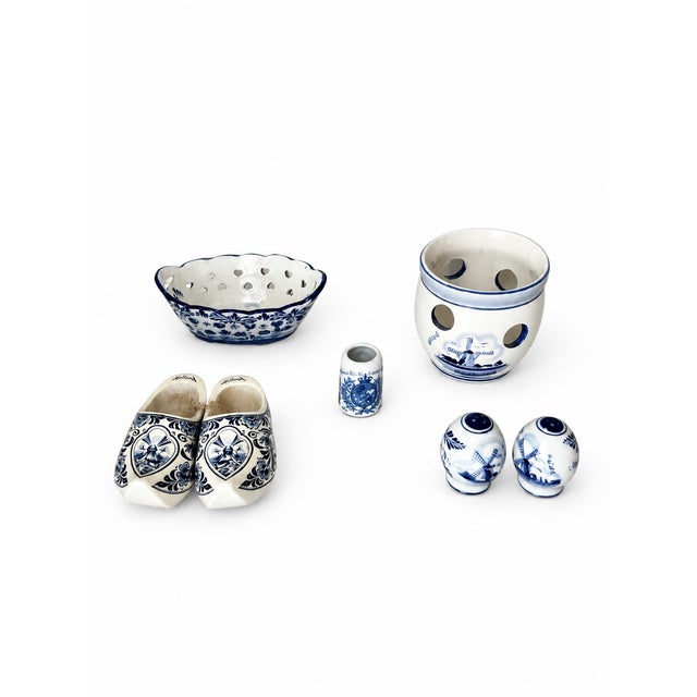 This seven-piece Dutch blue-and-white ceramic pottery set brings windmill scenes, cobalt florals, and varied shapes...