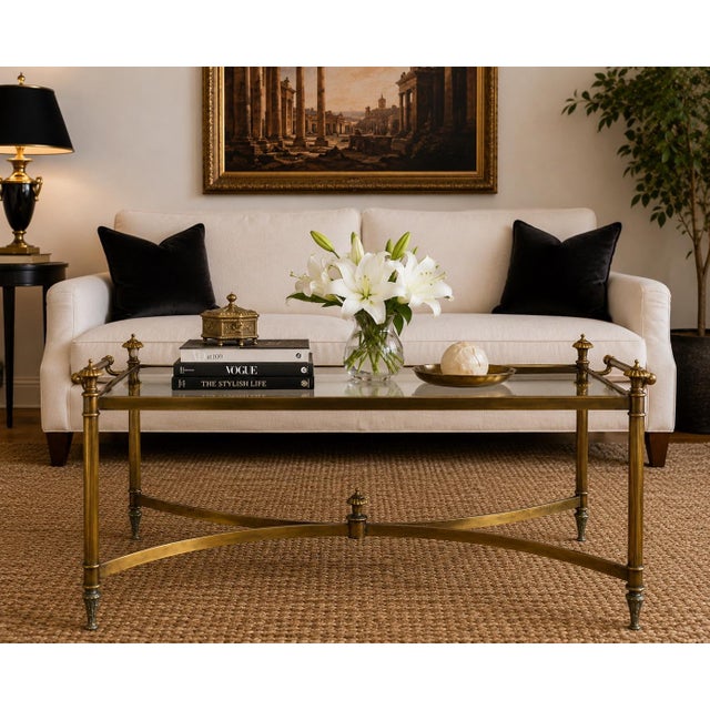 Elegant French Neoclassical brass cocktail table dating to the 1960s, featuring a beautifully proportioned architectural...