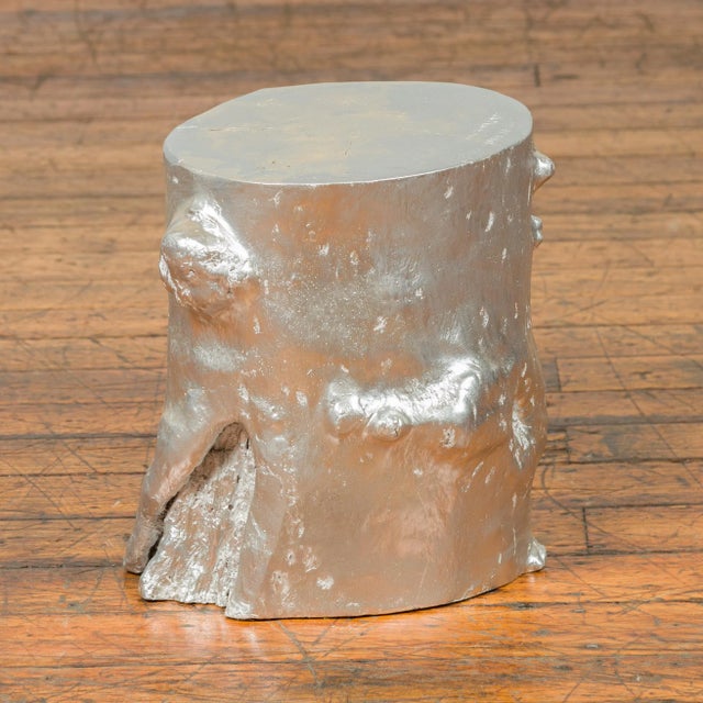 A contemporary Indonesian silver-colored tree stump pedestal. Crafted in Indonesia, this pedestal will charm you with its...