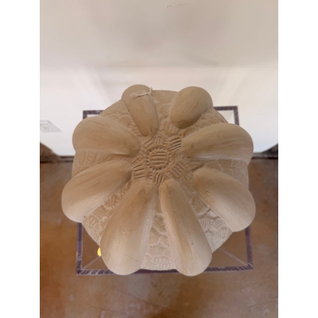 Contemporary coastal decorative sculpture inspired by a sea urchin shell, featuring a soft ivory finish with sculpted...