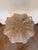 Contemporary coastal decorative sculpture inspired by a sea urchin shell, featuring a soft ivory finish with sculpted...