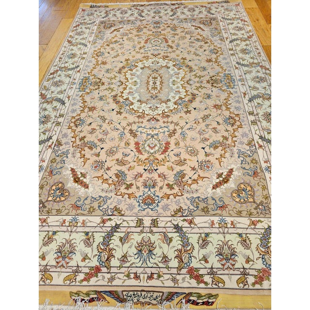 "An exquisite example of Persian artistry, this authentic room-size Tabriz rug showcases a delicate floral design woven...