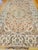 "An exquisite example of Persian artistry, this authentic room-size Tabriz rug showcases a delicate floral design woven...