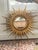 Super stylish sunburst mirror in cast metal. Gilded for the modern age. Mirror is 32" wide.