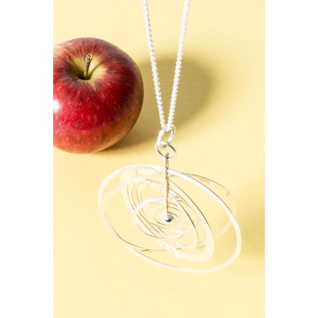 Iconic "Silver Moon" pendant by Tapio Wirkkala, with eight rings around the center. Made up of slender silver rings...