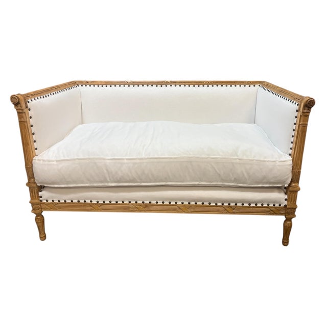19th Century French Directoire Settee. Nicely carved frame with new upholstery and nail head trim