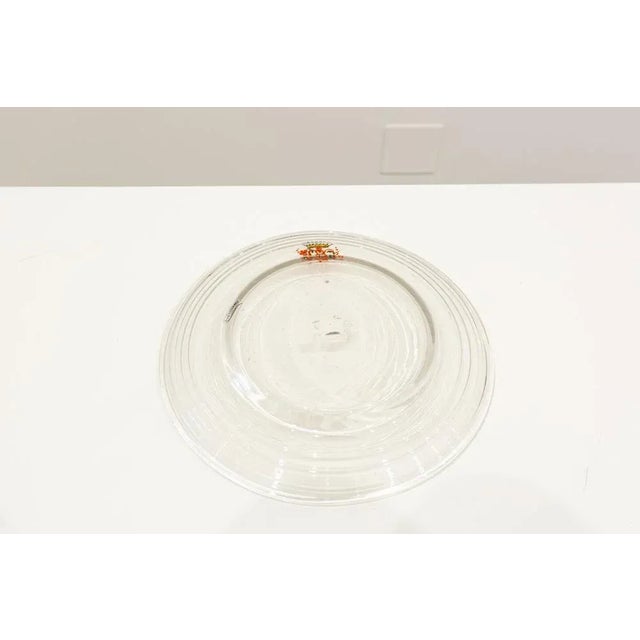Flat plate made of transparent blown glass with heraldic decoration in colored enamel on the eaves. Signed Gordiola...