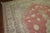 An oversize old Turkish Oushak rug, with ivory, soft brown, and light green accents and predominantly soft red tone, circa...