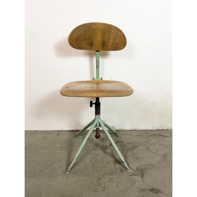This industrial height adjustable, rotating chair was made in former Czechoslovakia during the 1950s.It features a green...