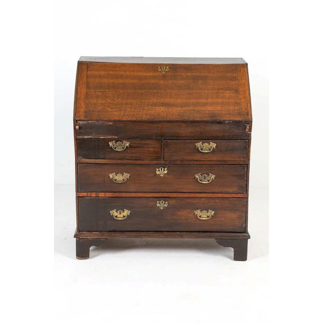 This handsome George III slant-front bureau, dating to the late 18th century (circa 1780), is a quintessential example of...