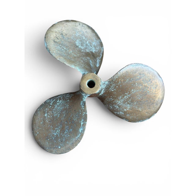 This is a antique bronze boat propeller featuring a heavily oxidized, blue-green verdigris patina caused by long-term...