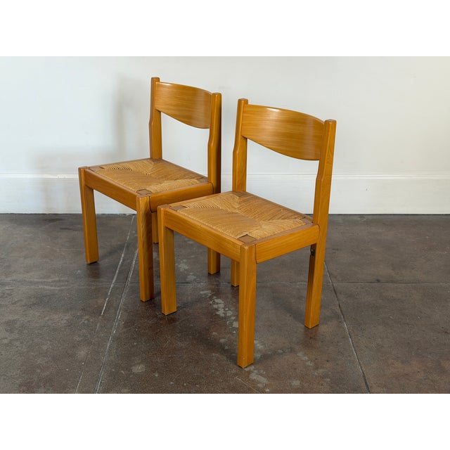 1970s set of four Maison Regain solid elm and rush dining chairs in good vintage condition. Signature sticker of french...