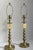 A refined pair of Ralph Lauren buffet lamps featuring a warm antique brass finish and elegantly turned ball-form stems....