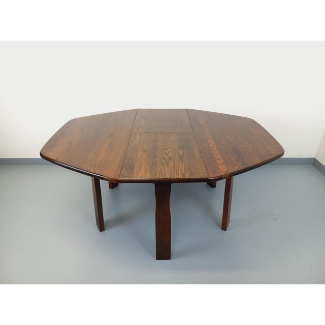 Vintage hexagonal dining table from the 1950s, with a brutalist and minimalist rustic design, made of solid dark oak, with...