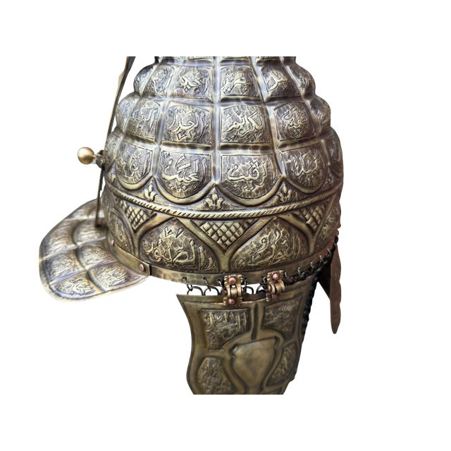 Forged Devotion: The Esma-ul Husna Helmet This solid brass armor transcends traditional metalwork, serving as a canvas for...