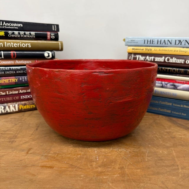 "About This Piece About This Piece This striking hand-lacquered bowl radiates warmth and energy, its surface glowing in...