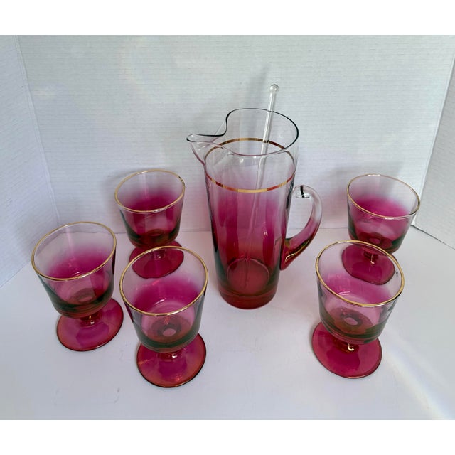 This beautiful mid-century barware set, attributed to Blendo production by West Virginia Glass, dates to the mid-20th...