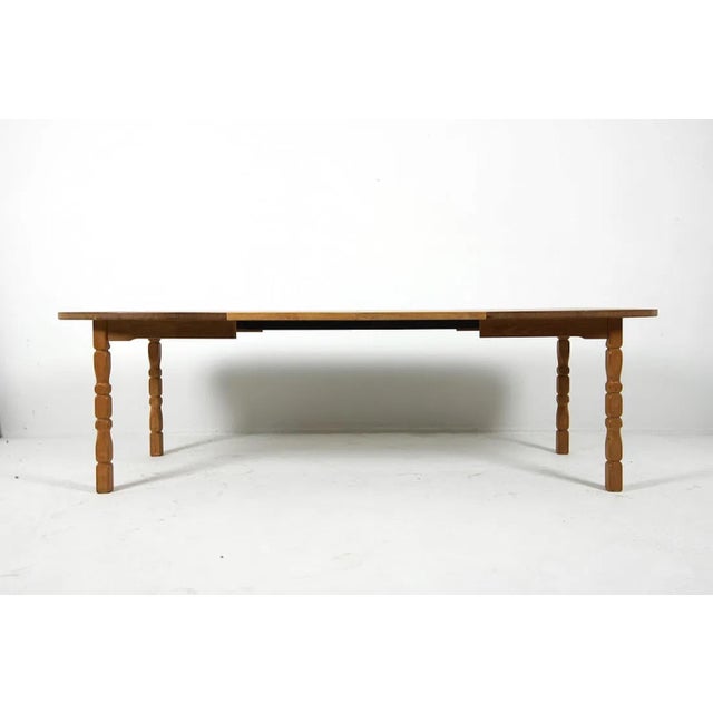 Oak dining table with an oval top. The table is raised on turned legs with carved detailing. Construction and proportions...