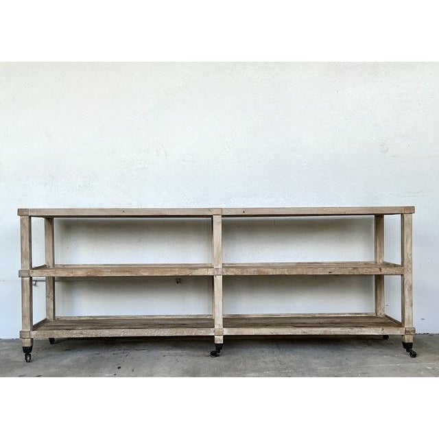 This large-scale console table exudes a timeless, rustic charm with its heavy plank wood construction and beautifully...