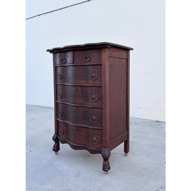 A beautifully crafted antique dresser inspired by the graceful lines of 18th-century French Louis XV furniture. Crafted...