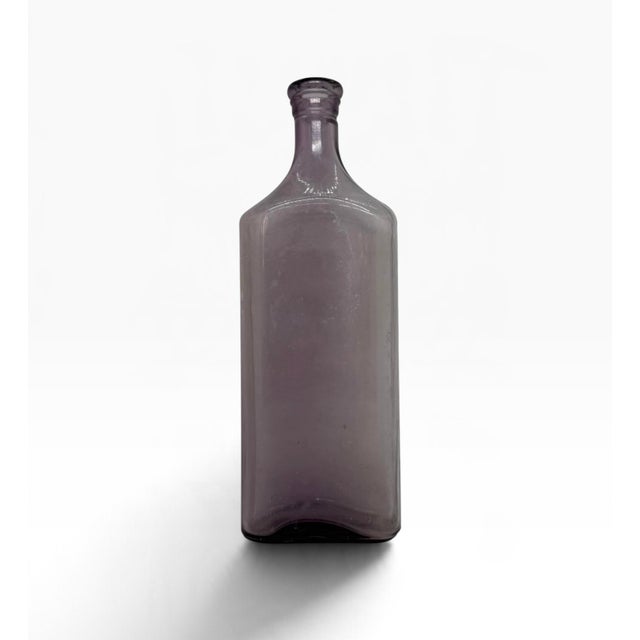 Antique Sun-Purple Amethyst 10 3/4” Medicine Bottle made by the Illinois Glass Company. It has on the bottom a single...