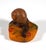 Pâte de verre presse-papiers 'escargot': a dark brown snail with a light brown shell, crawling over scattered green twigs...