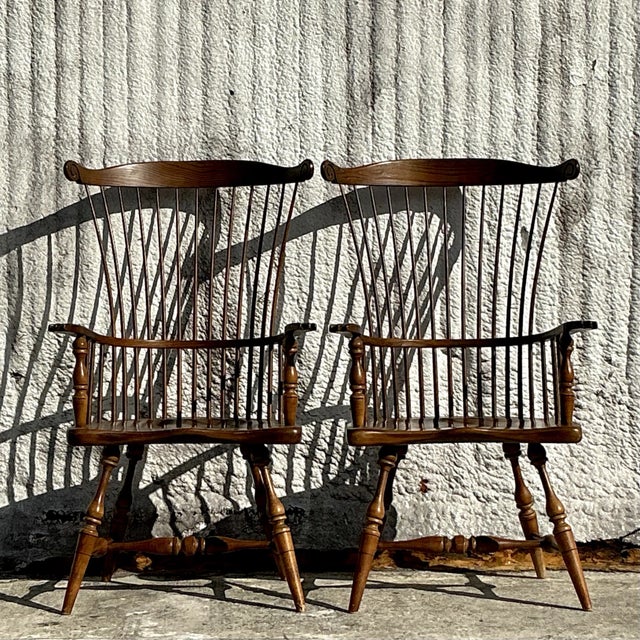 A classic pair of vintage Duckloe Brothers high-back Windsor chairs, showcasing traditional craftsmanship and timeless...