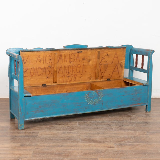 Original hand painted folk art pine bench with colorful blue background and floral motif in painted panels. Solid back,...