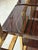 A beautiful room divider or book case in brass with macassar ebony veneered wood base and shelves. The Demi lune shaped...