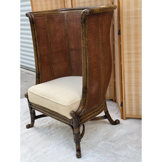 Exquisite late 20th-century British Colonial-style wingback chair by renowned luxury maker Maitland-Smith. This striking...