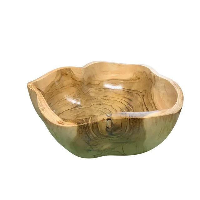 This teak live edge bowl is a unique piece showcasing the natural beauty of teak wood. Crafted by skilled artisans, its...