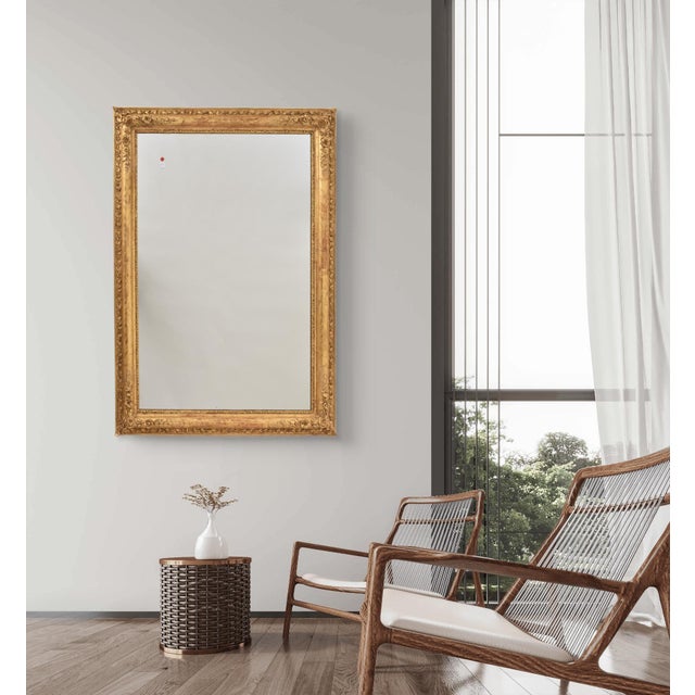 The elegant Antique Gilt Mirror, rectangular in shape, presented here and dating from the mid-19th century, features...