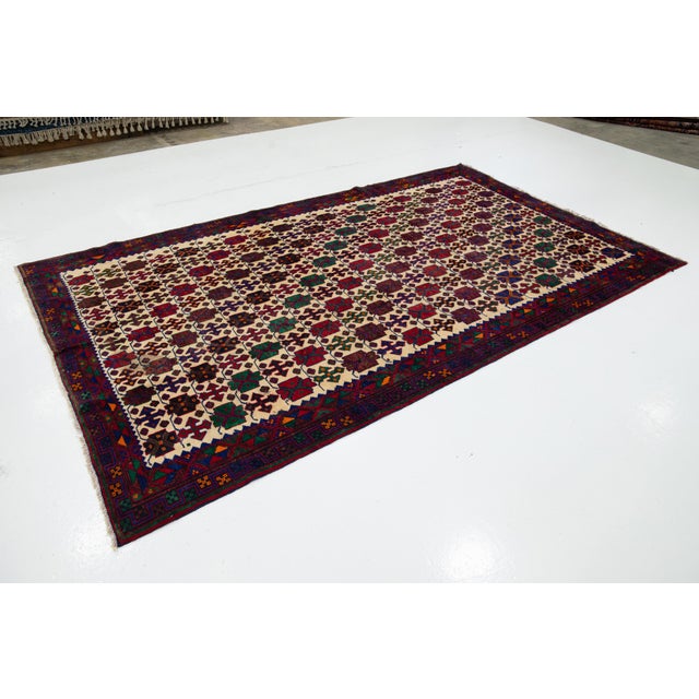 This is a beautiful vintage Bidjar hand-knotted wool rug with a beige field. It has multicolor accents and an all-over...