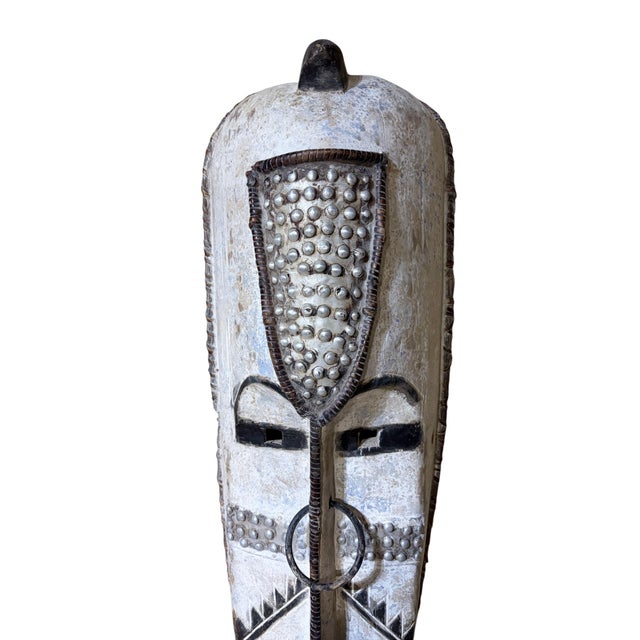 Superb vintage Fang mask carved from a single piece of heavy wood, featuring an elongated heart-shaped face rendered in...