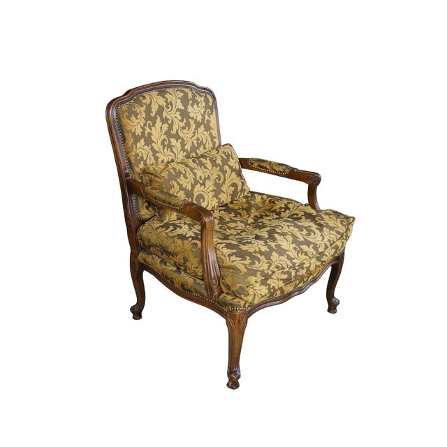 This exquisite vintage French Provincial style bergère armchair showcases the timeless elegance of fine Italian...