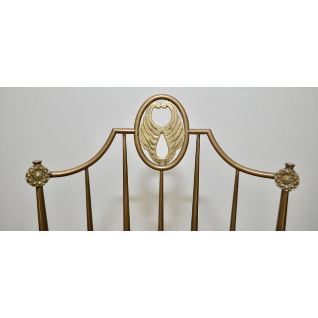 Antique chairs with a brass frame and seating in fabric.