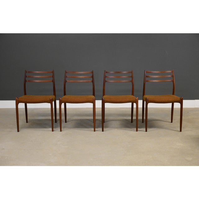 A set of four mid century modern teak model 78 dining chairs by Niels Moller. Made in Denmark. Professionally refinished...
