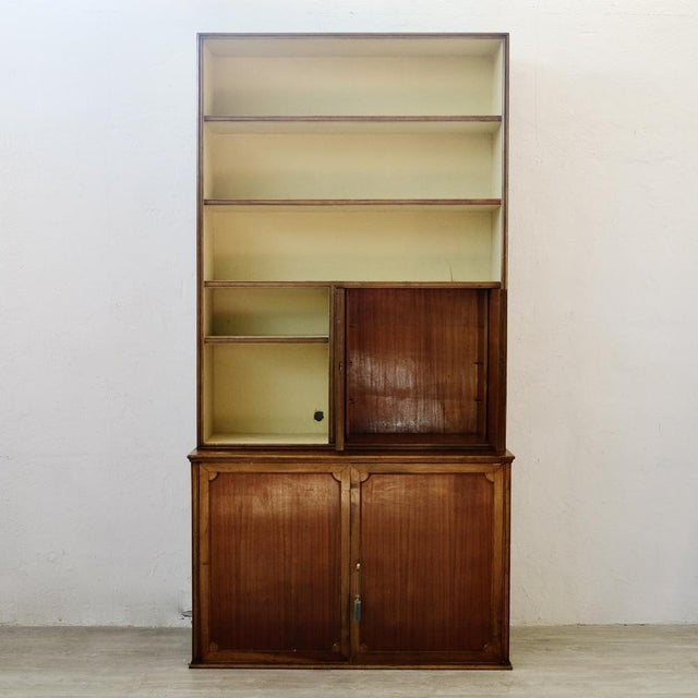 Original wooden bookcase, two-tone, composed of 3 shelves in the upper part, in the central part there are two open...