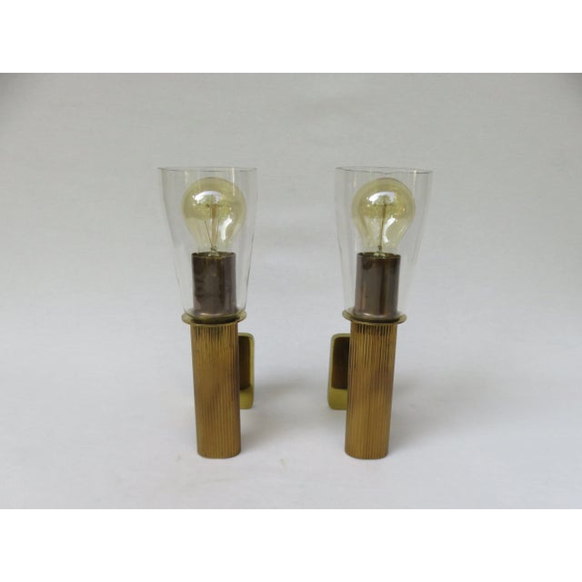- Torch wall lamps - Made of brass with blown glass screens - With the typical streaks and air bubbles - The glass shade...