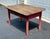 This exceptional 19th-century primitive farmhouse table features a beautifully weathered, scrubbed pine plank top paired...