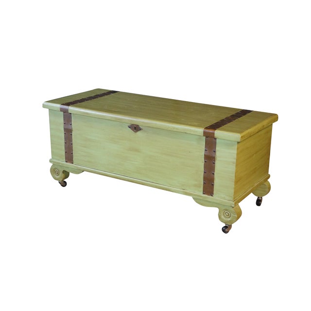 This rectangular blanket chest combines vintage charm with functional mobility, featuring a distressed green painted...