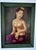 A captivating vintage oil on canvas portrait depicting a serene young Balinese woman seated in traditional attire....