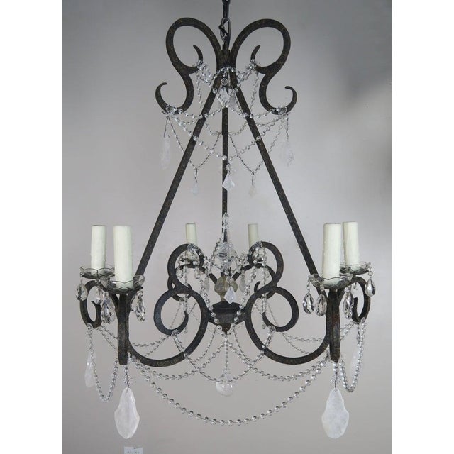 20th century hand wrought iron six light chandelier adorned with rock crystal pendulum shaped drops and garlands of...