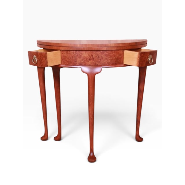 Offered here is a Baker Furniture petite Queen Anne style flip top demilune console table or entry table. Made of solid...