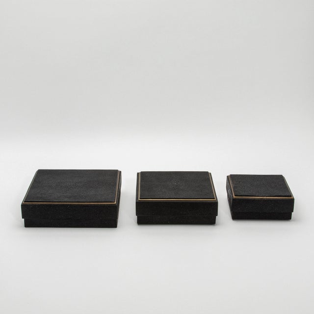 This set of three square boxes by R&Y Augousti is a masterclass in luxury craftsmanship, merging sleek design with...