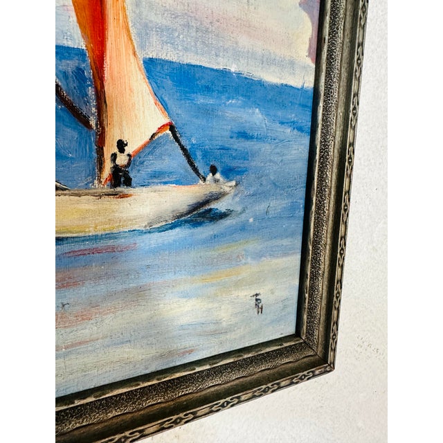 This vintage oil painting captures a serene maritime scene, depicting a sailboat gliding across calm blue waters under a...