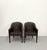 A sophisticated pair of Walter E. Smithe custom barrel armchairs featuring rich dark brown tufted leather upholstery...