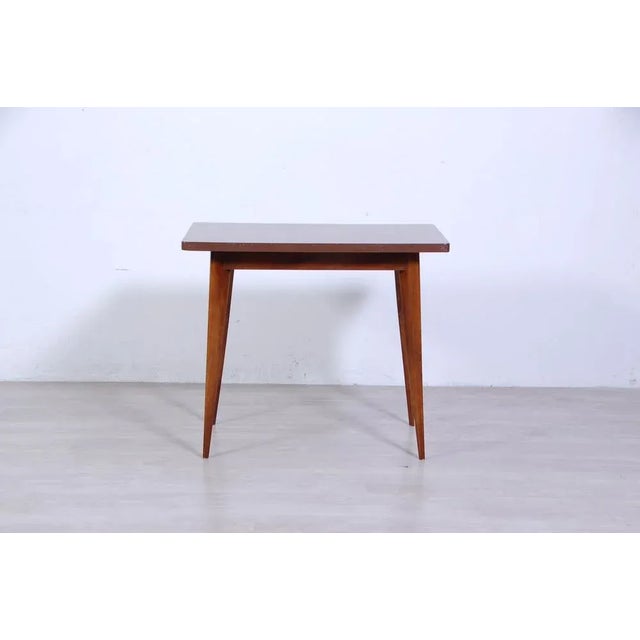 Cute table design and original 1950s production table. Made with wooden structure and top covered in ant. The four slender...