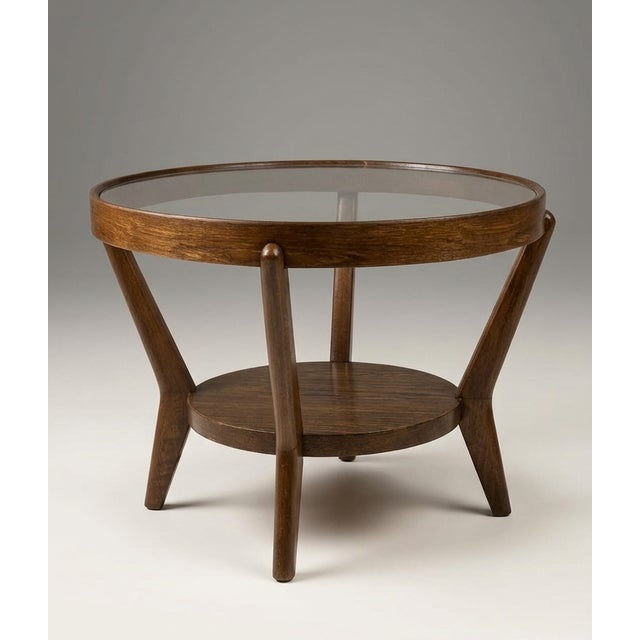This sculptural round coffee table was designed by Karel Koželka and Antonín Kropáček around 1944 as part of an award-...
