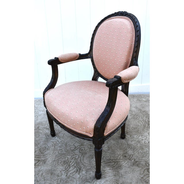 Antique Bergere Chair has a French Style. The Frame is Wood. Solid & Sturdy. Peach Colored Patterned Fabric. Minor Stains....